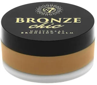 W7 Bronze Chic Universal Bronzing Balm jar, featuring a sleek black lid and a golden-brown balm inside.